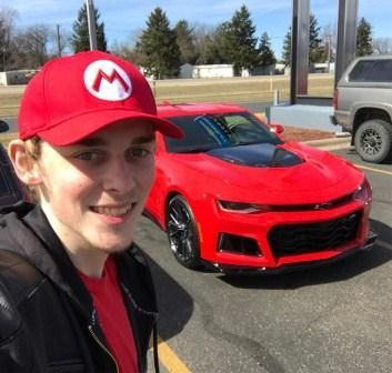 Logan Thirtyacre with his car