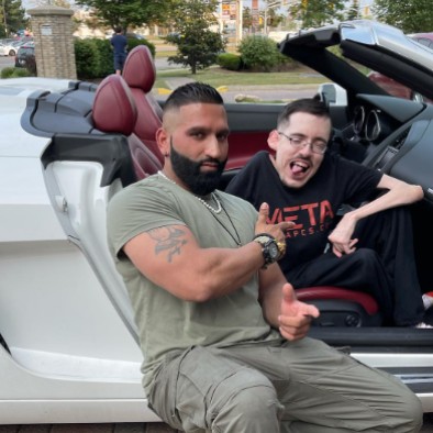 Ricky Berwick posing in the car with is friend 