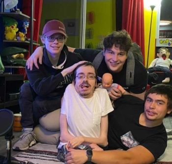 Ricky Berwick posing with his friend inside the house