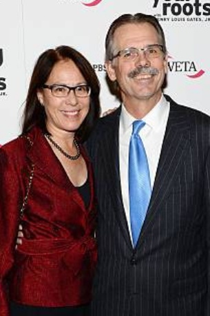 Debbie Hutchins with her husband, Glenn Hutchin posing on the red carpet Hutchins