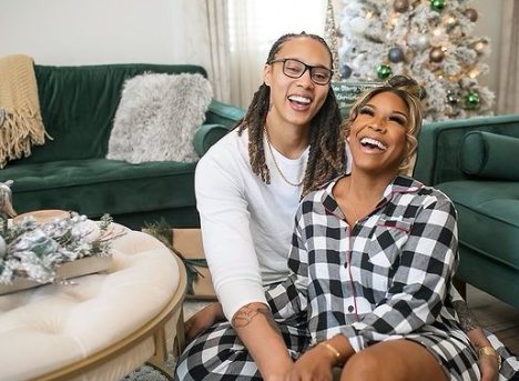 Cherelle Griner posing inside her lobby with her partner