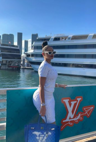 Kalabrya Gondrezick infront of the yacht