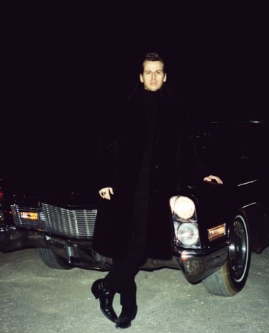 Mark Foster posing infront of the car 