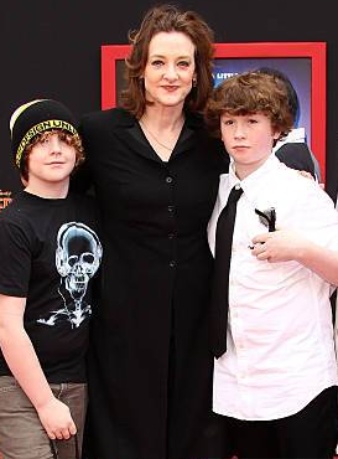 Dylan John Burke posing with his mother and brother 