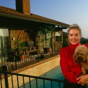 Maureen Dean posing infront of the house with her dog