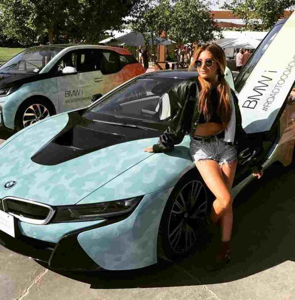 Ashley Tisdale posing with her car