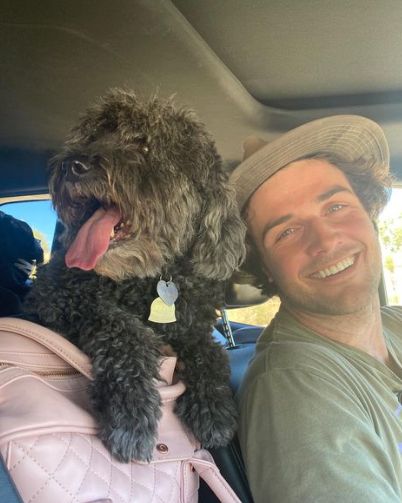 Beau Mirchoff with his dog inside his car