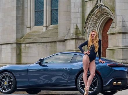 Joshua Brgasse's wife Sara Ann Mearns posing with her car