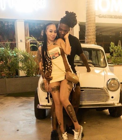Jaimie Marie with husband posing with car