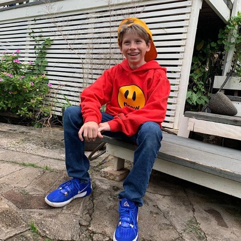 Mason Ramsay posing with his house