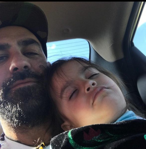 Chris Nunez inside his car with his daughter