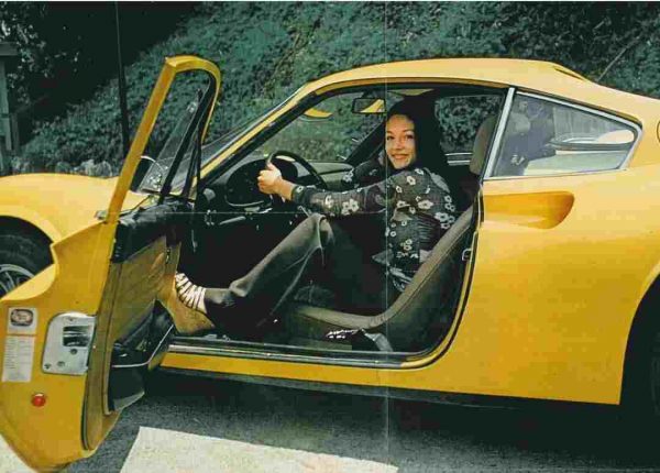 Akira's ex-wife Olivia Hussey posing inside the car