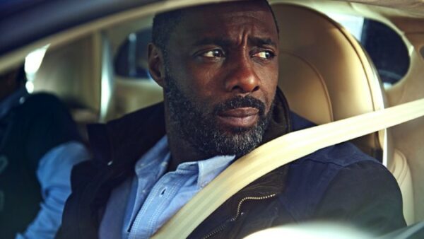 Idris posing in his car