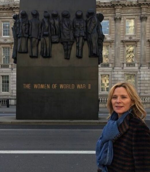 Kim poses in front of the house 